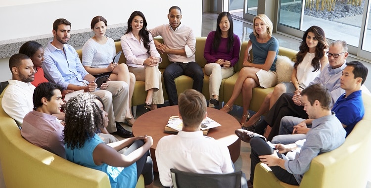 Multi-Cultural Office Staff Sitting Having Meeting Together